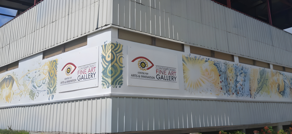 Fine Art Gallery sign on a building facade with artistic designs.