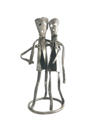 Metal sculpture of two figures holding hands on a white background