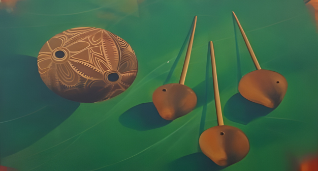 Decorative wooden items with intricate designs on a green surface